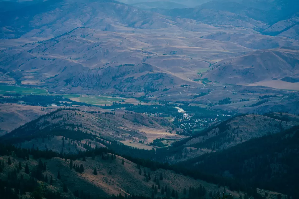 Aerial view of small rural community nestled in sprawling green valley in Washington State